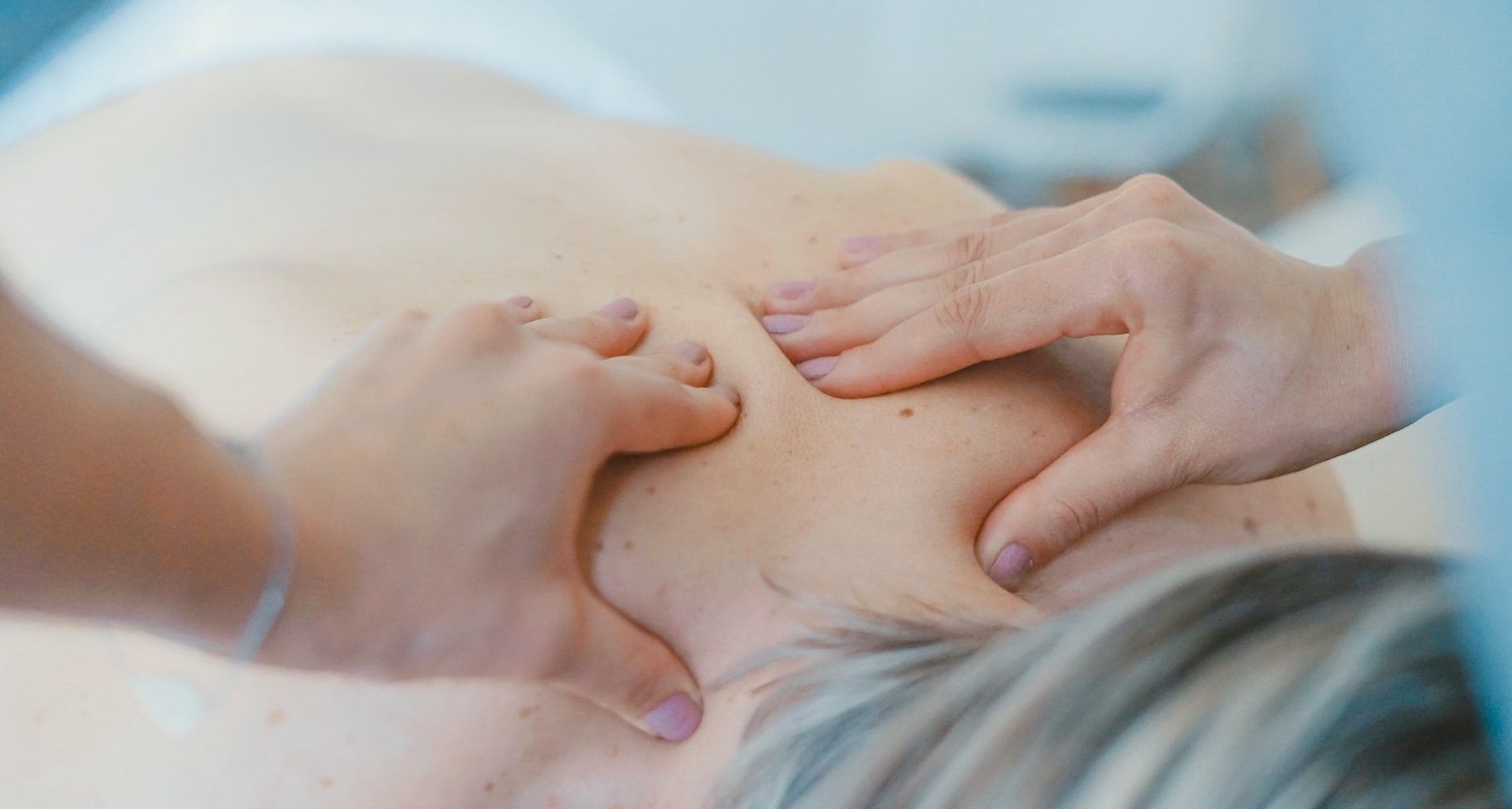 A woman receiving a back massage at an Old Hospital.