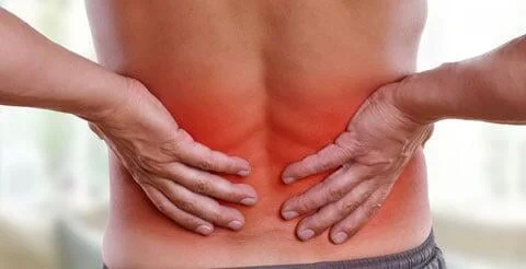 A man with low back pain seeking relief through simple methods.