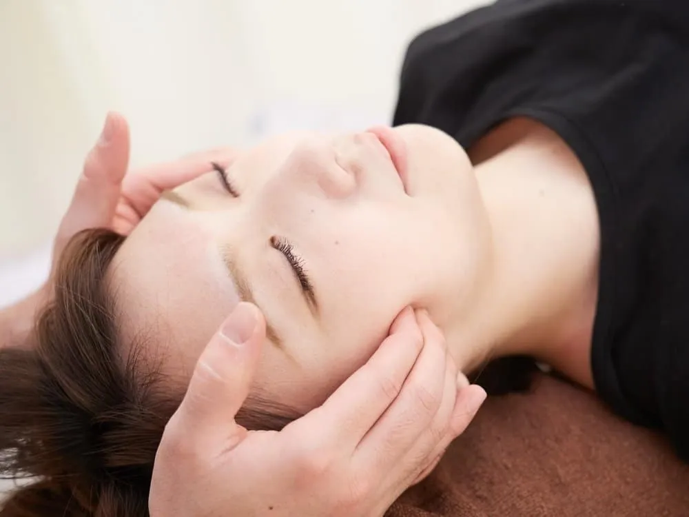 Woman receiving osteopathic treatment for migraines